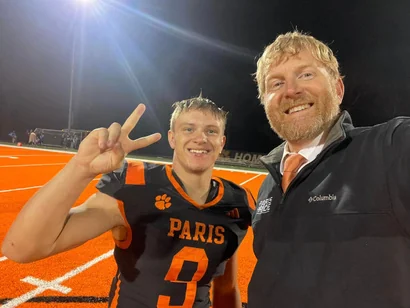 Stephen McCauley celebrating with a Paris student athlete at a school event