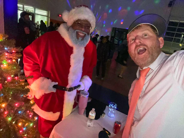 Stephen McCauley hosting and DJing a district holiday event